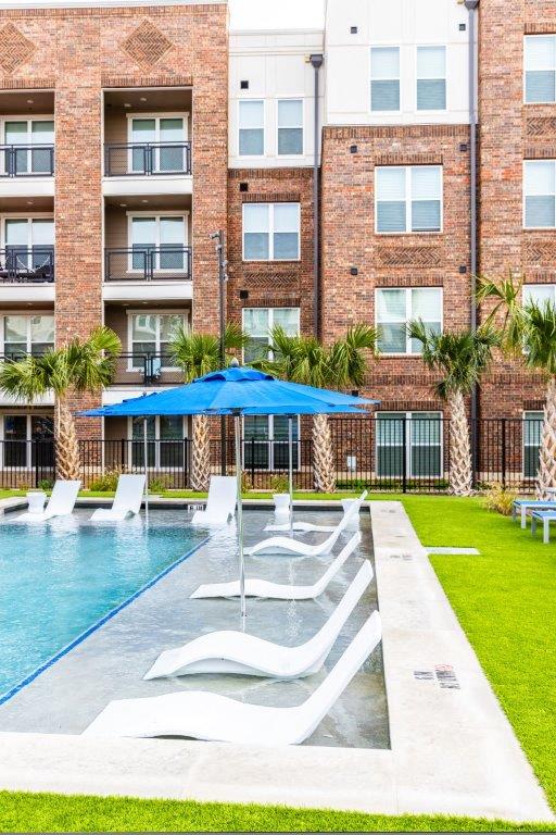 Resort style pool with lounge chairs at Heritage Towers