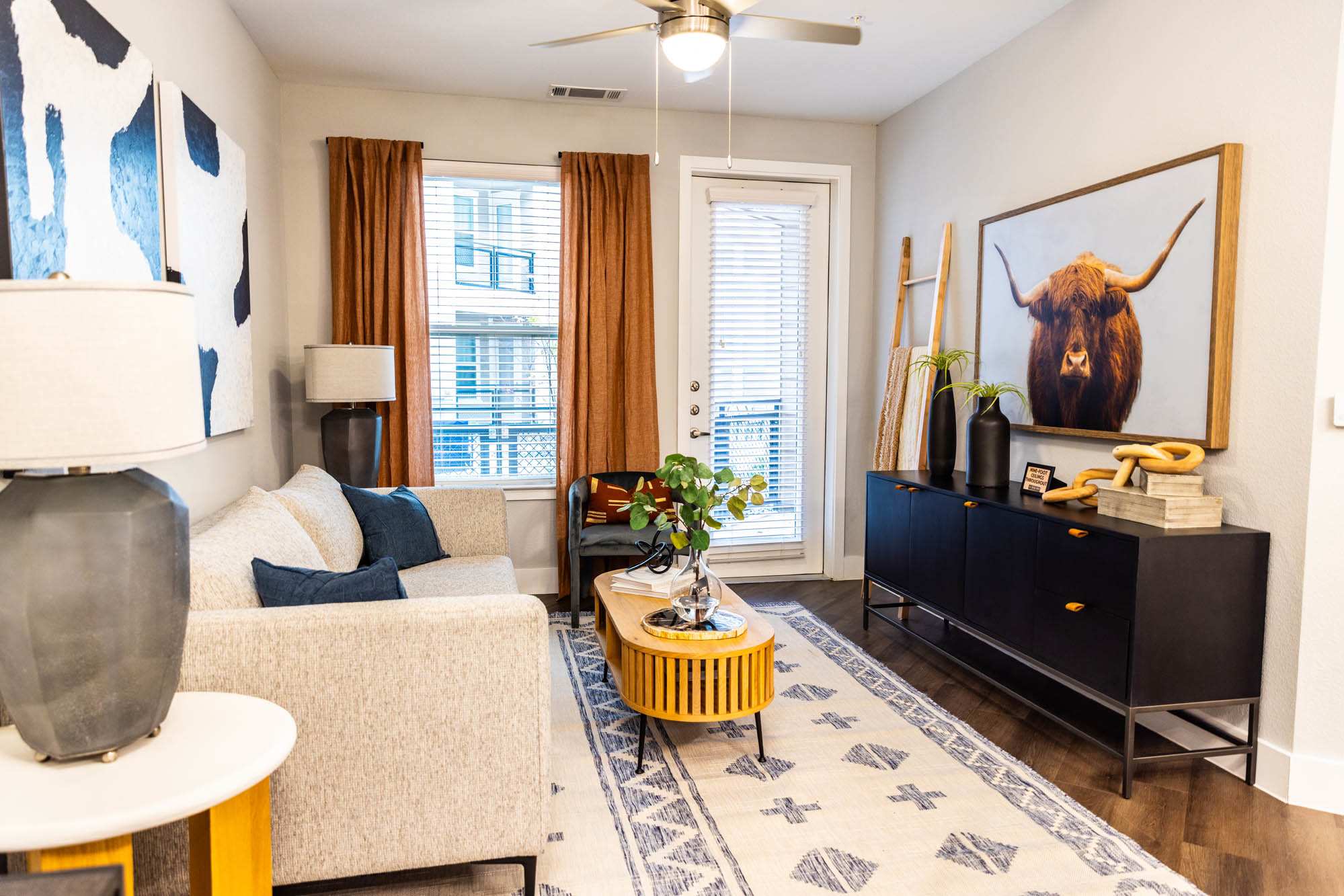 A living room with a couch, a television and artwork