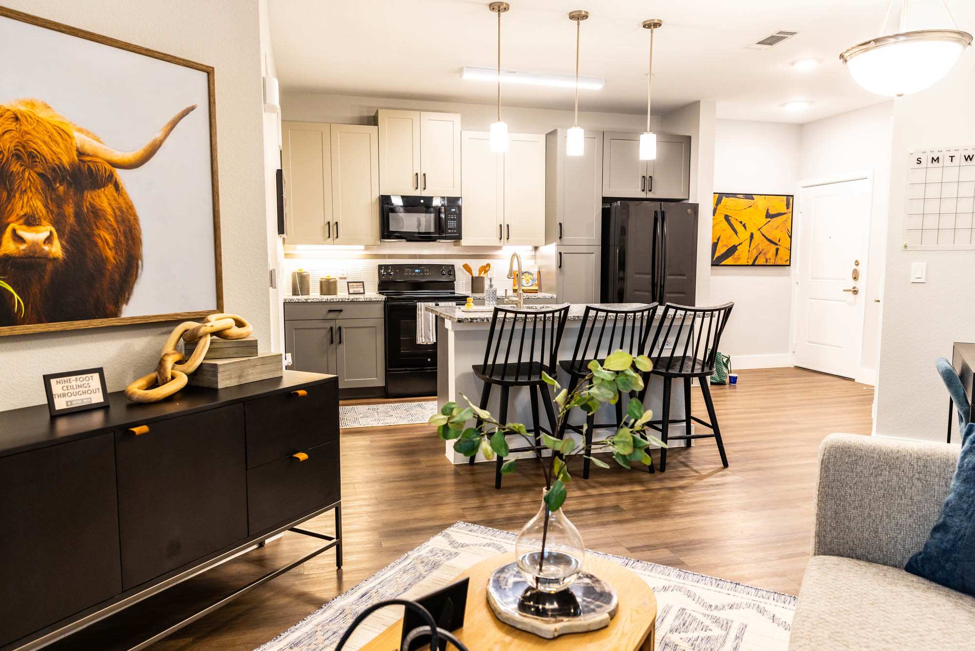 A living room with a kitchen and a dining room