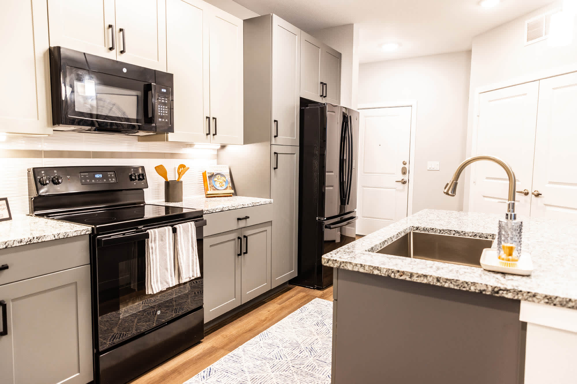 A kitchen with appliances and granite counter tops