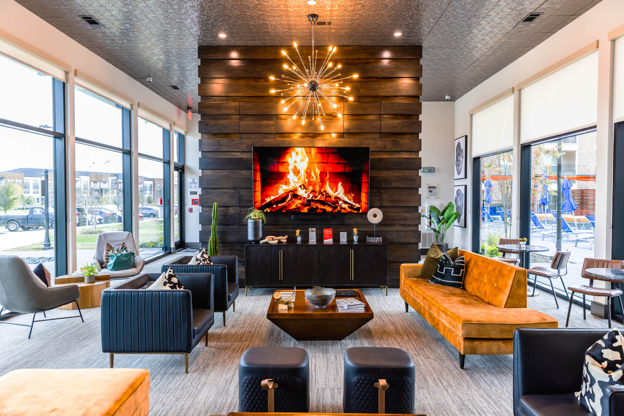 A living room with a fireplace and seating by a window